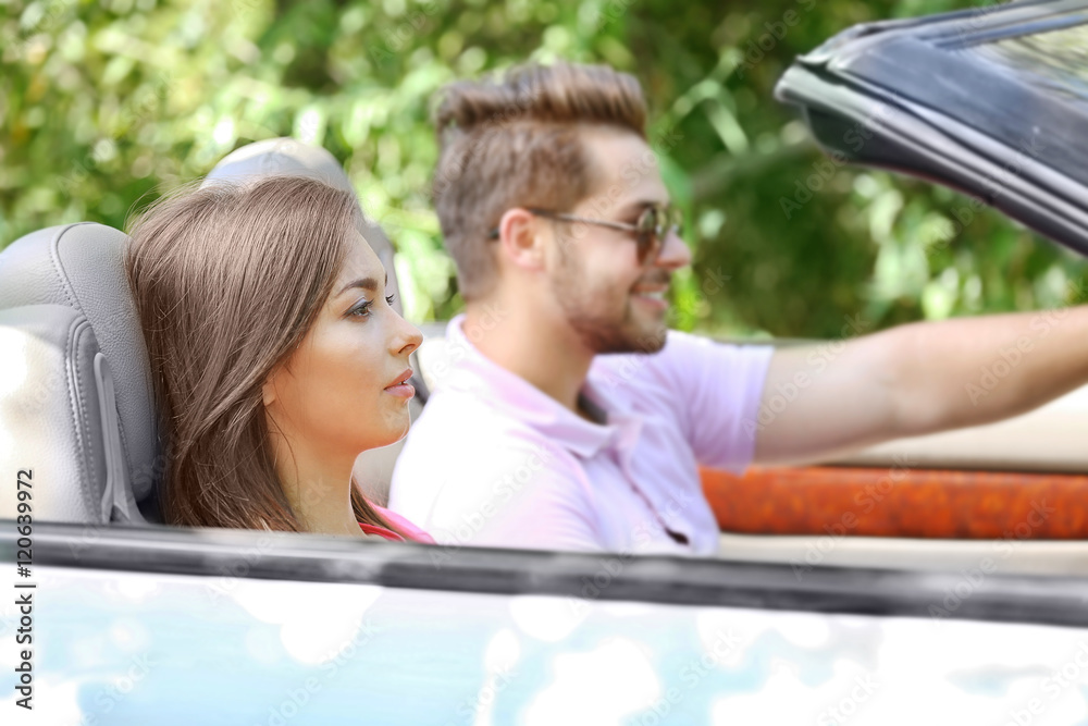 Beautiful couple in car on road trip