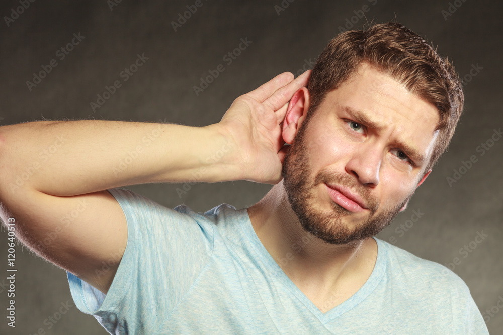 Gossip man eavesdropping with hand to ear. Gossip man eavesdropping with hand to ear.