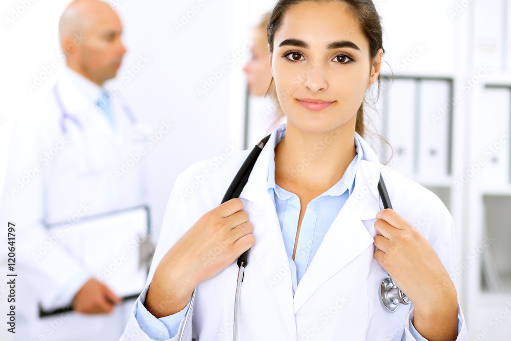 Happy doctor woman with medical staff at the hospital Happy doctor woman with medical staff at the hospital