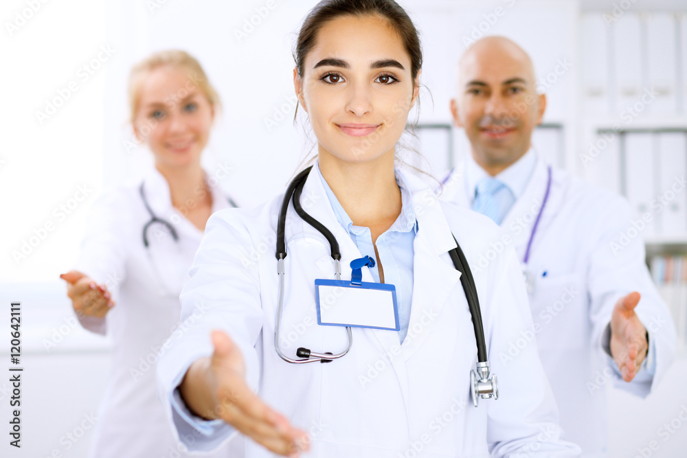 Happy doctor woman with medical staff at the hospital. Helping hand! Happy doctor woman with medical staff at the hospital. Helping hand!