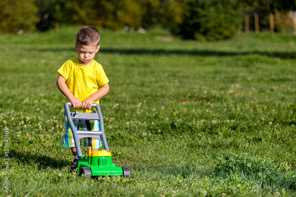 child mowing grass child mowing grass