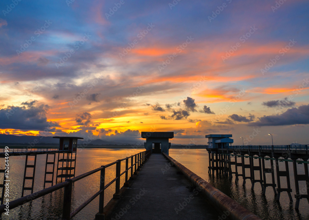 Fototapeta premium Long exposure of abandoned bridge at Bang Phra Reservoir in the Sun rise , Si Racha District , Chonburi Province, Thailand