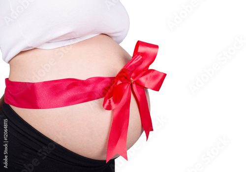 Wallpaper Mural close up pregnant woman with red ribbon gift on belly isolated o Torontodigital.ca
