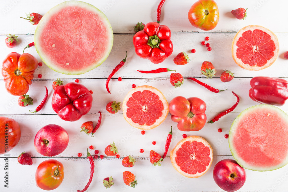 Red fruits and vegetables on a white on a wooden background Stock Photo