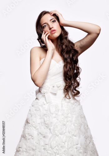 Portrait of beautiful young brunette woman bride in white Weddi