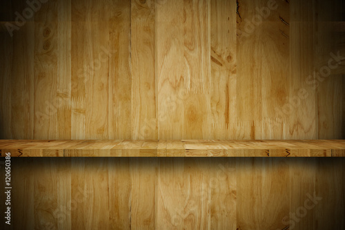 Empty top wooden shelf in front of a grunge wood wall.background. For montage product display