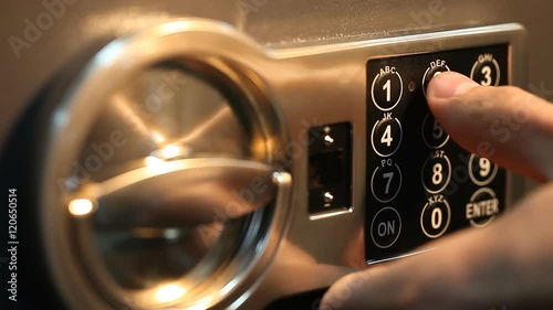 man opens the safe with a coded lock close up