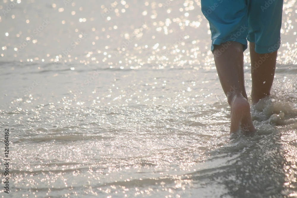 blurred movement of a boy in the walk on the sea blurred movement of a boy in the walk on the sea