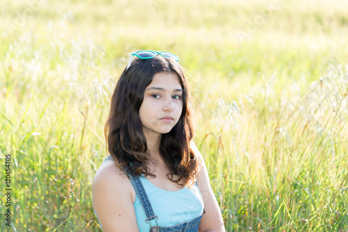 Portrait of sad teen girl on nature
