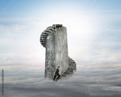 Billede på lærred Businessman climbing concrete spiral staircase tower over clouds
