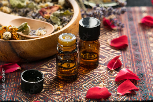 essential oils with dried herbs and roses