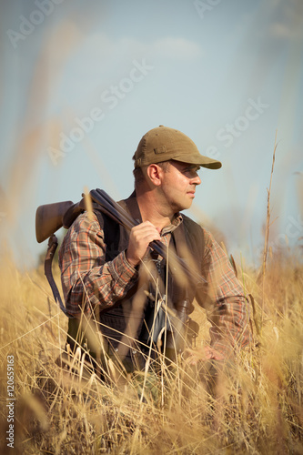 Hunter With Open Shotgun On Shoulder