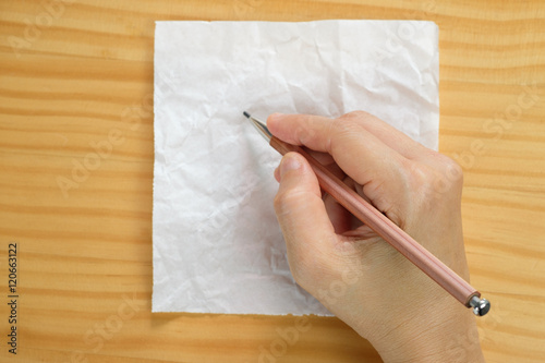 Woman writing on blank paper sheets