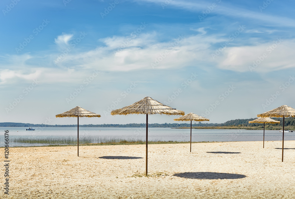 Sunshades on the beach at the lake. Sunshades on the beach at the lake.