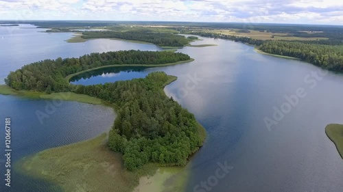 View of small islands on the lake in Masuria and Podlasie district, Poland. Blue water and whites clouds. Summer time. View from above. photo