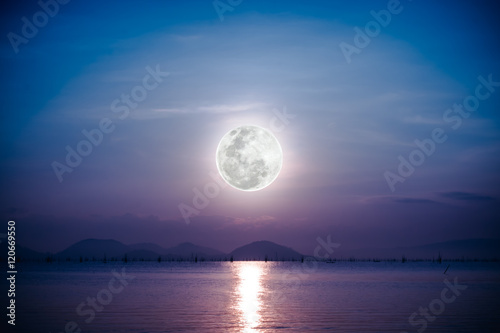 Romantic scenic with full moon on sea to night. Reflection of moon