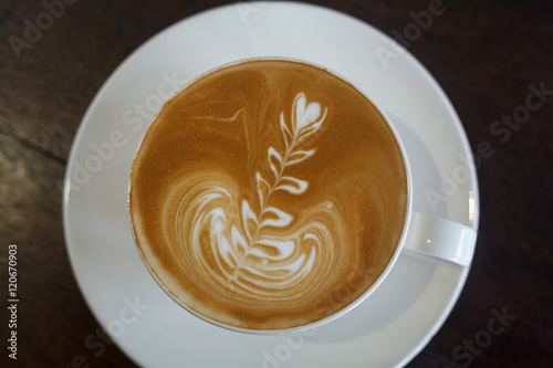 Top view latte art coffee on wood background..