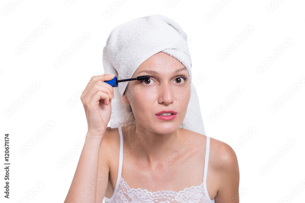 Woman applying black mascara on eyelashes with makeup brush Woman applying black mascara on eyelashes with makeup brush