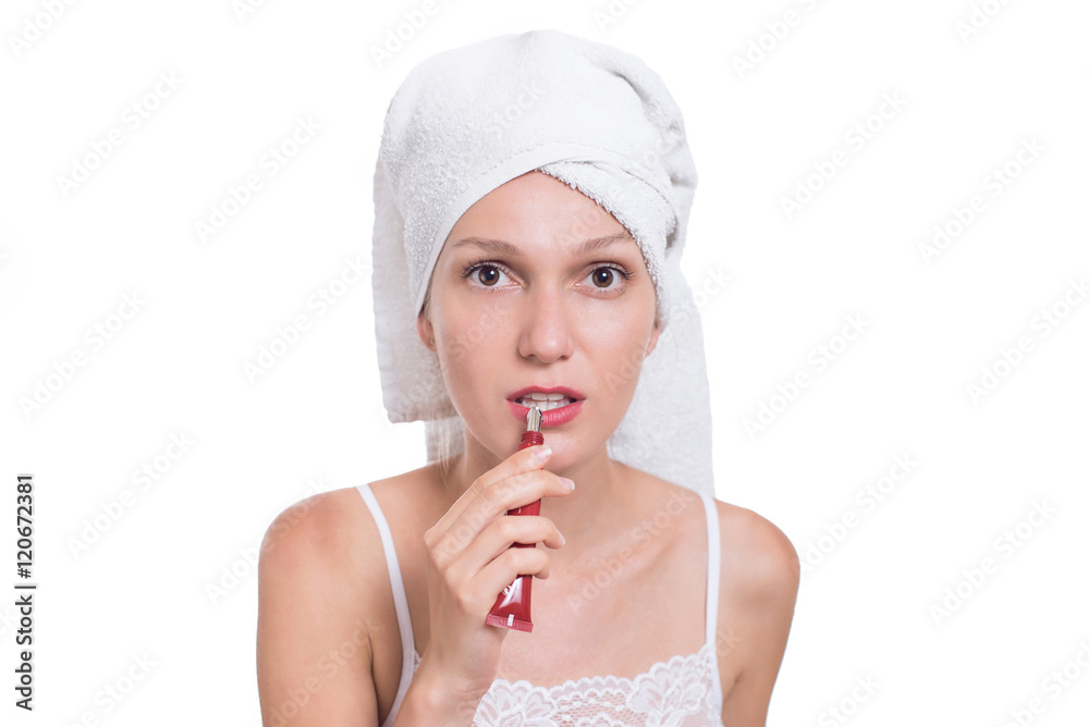 Young woman putting lipstick, lip balm care