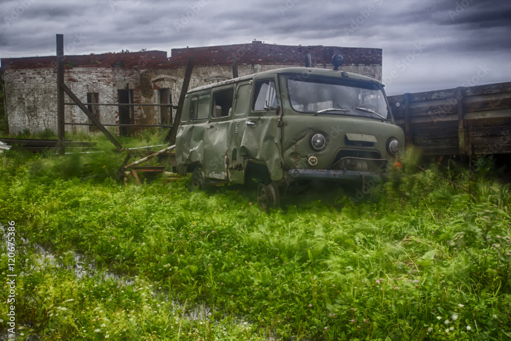 Apocalyptic scenery with old rusty Soviet car