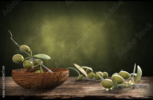 wooden bowl with olive branches photo