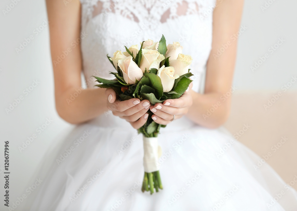 Bride in beautiful dress holding wedding bouquet Bride in beautiful dress holding wedding bouquet