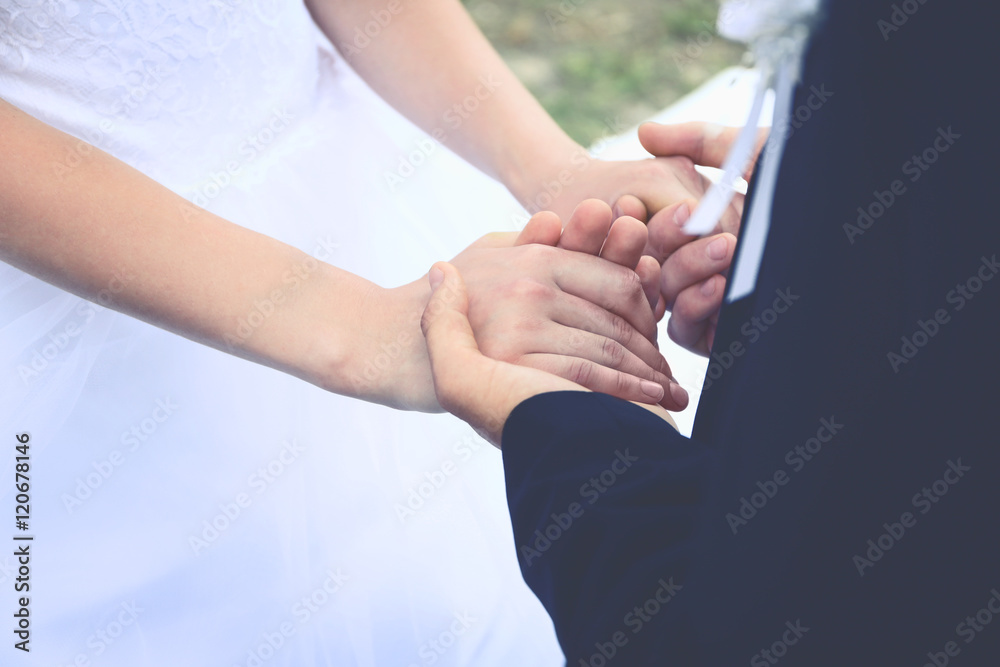 Fiancee and fiance holding hands, closeup Fiancee and fiance holding hands, closeup