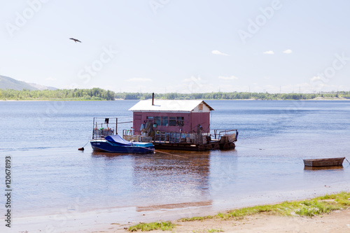 houseboat on water of river in summer