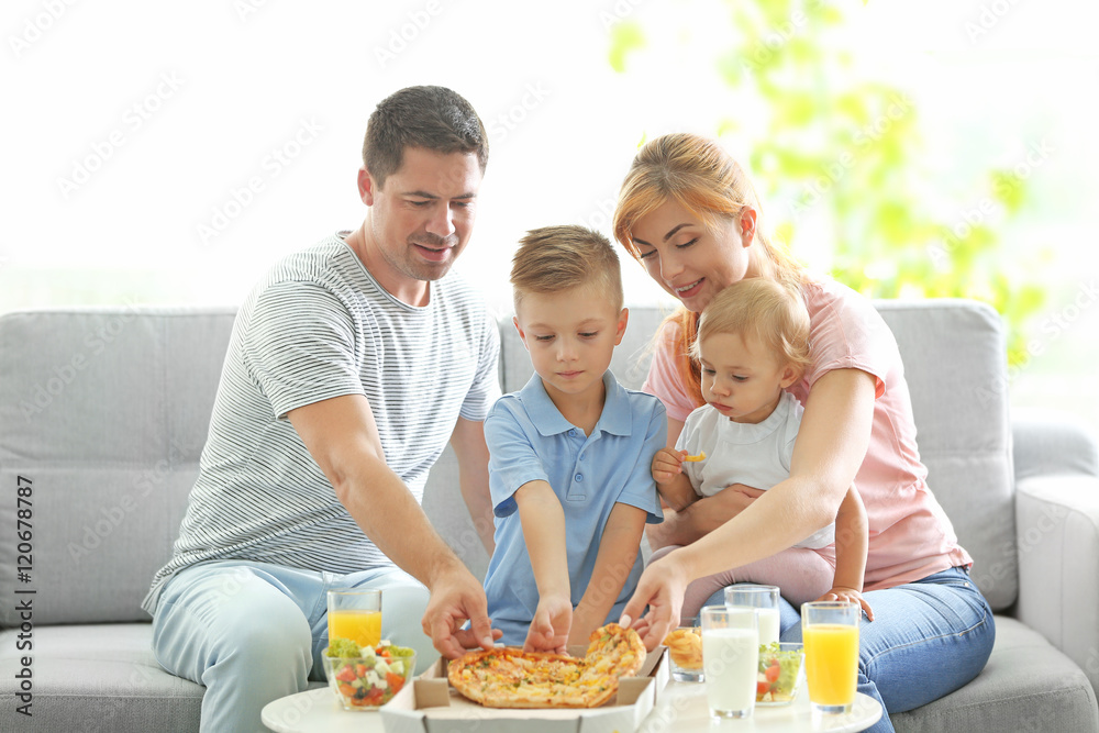 Happy family dining in living room Happy family dining in living room