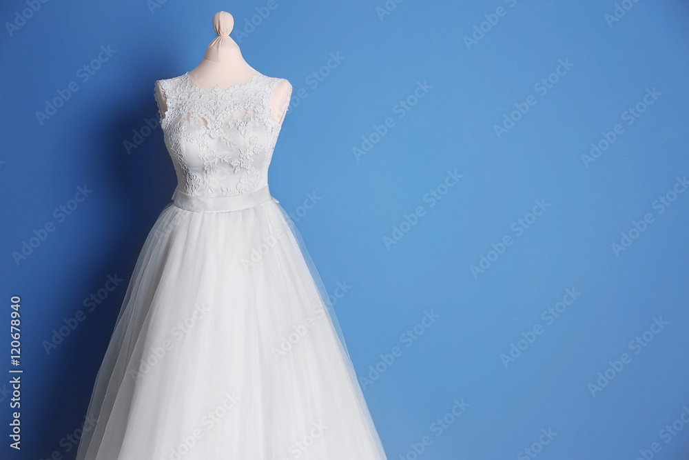 Beautiful wedding dress on wall background Beautiful wedding dress on wall background