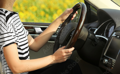 Pretty young woman driving car