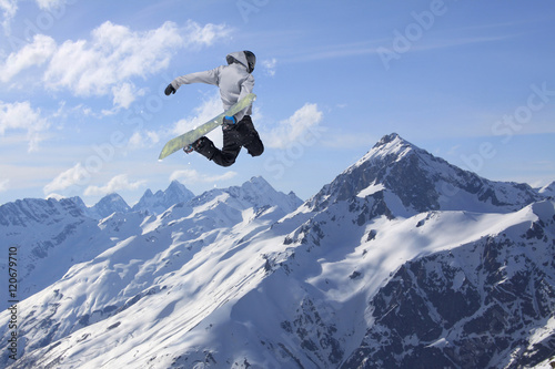 Snowboarder jumping in snowy winter mountains © Vasily Merkushev
