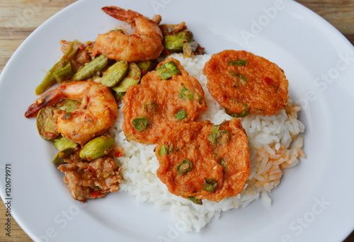 fried fish cake and spicy stir fried twisted cluster bean with shrimp on rice