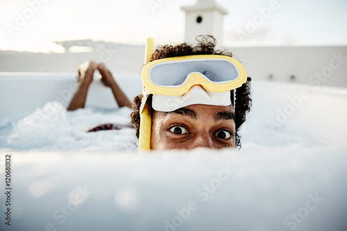 boy in pool with swimming goggles