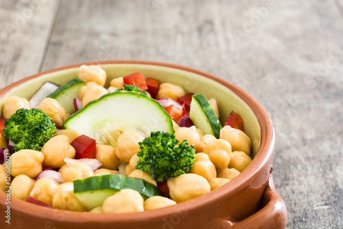 Chickpea salad isolated on wooden background