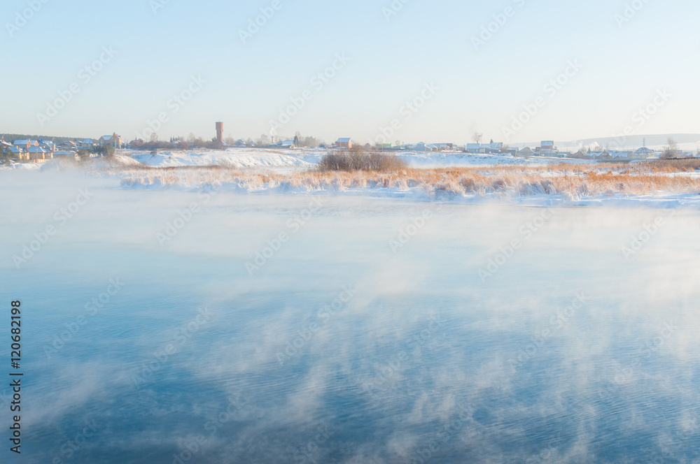 Heavy frost in the circumpolar village, vapor above the river