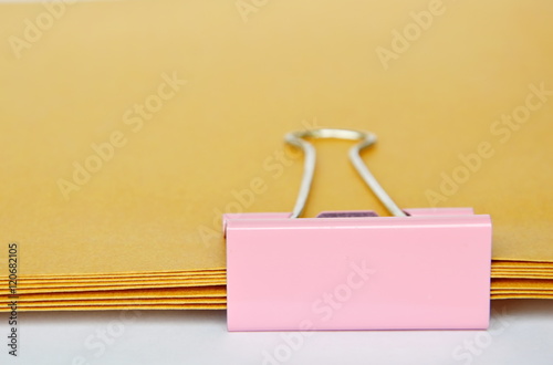 pink stamp paper clip on brown envelop overlay