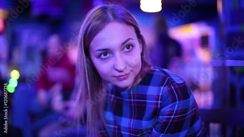 Beautiful young woman in a nightclub waiting start of the show.