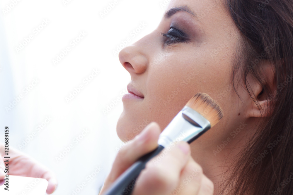 The power of make up,beautician woman applying professional make up to a beautiful young girl The power of make up,beautician woman applying professional make up to a beautiful young girl
