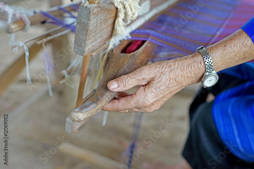 woman hold wooden bobbin