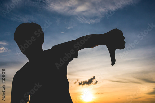 Silhouette with man's thump down