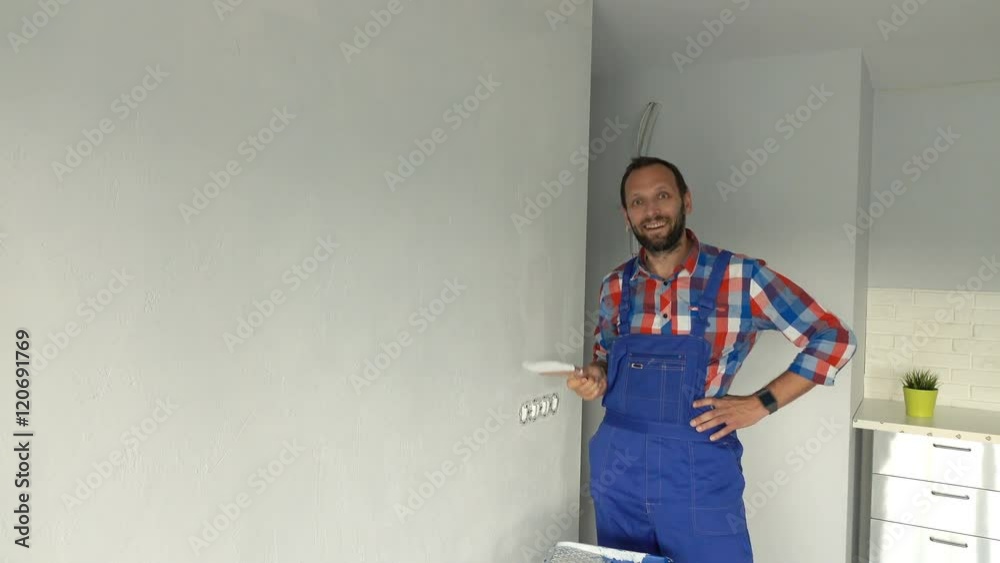 Portrait of happy male worker painting wall at new home
Portrait of happy male worker painting wall at new home