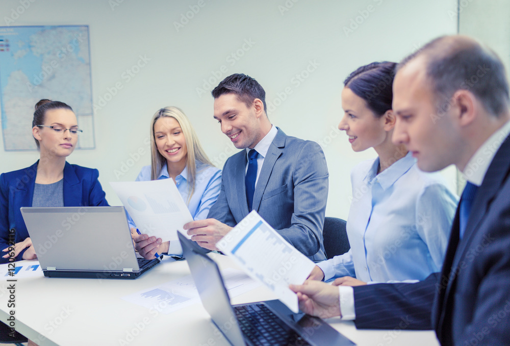 business team with laptop having discussion