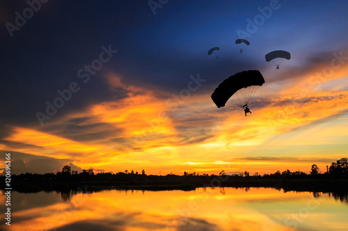 parachute at sunset silhouetted