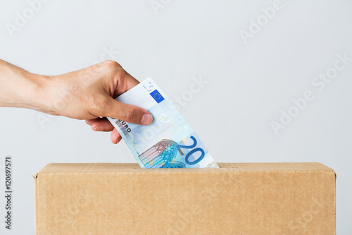 Fototapeta man putting euro money into donation box
