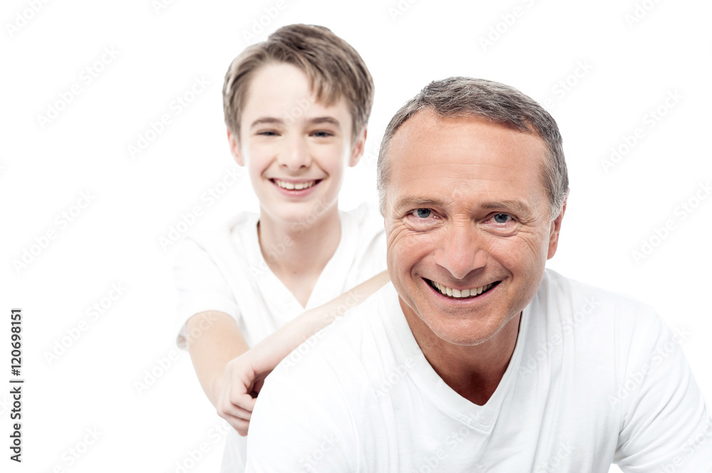 Smiling mature father and son posing