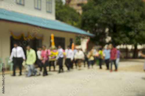 Blurred motion of thai people join in traditional processional c