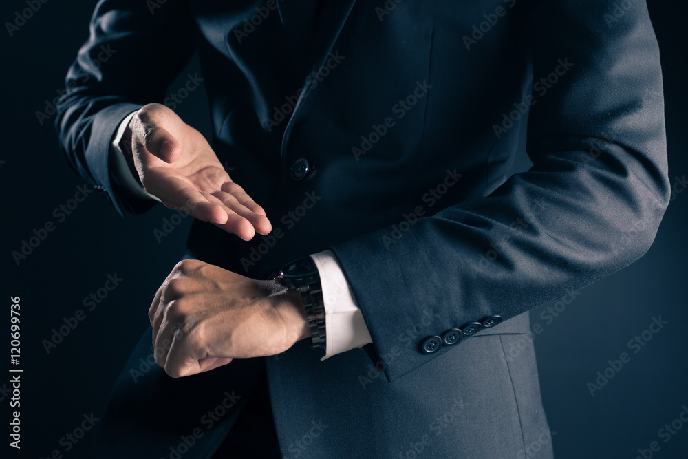 Businessman checking time from watch Businessman checking time from watch