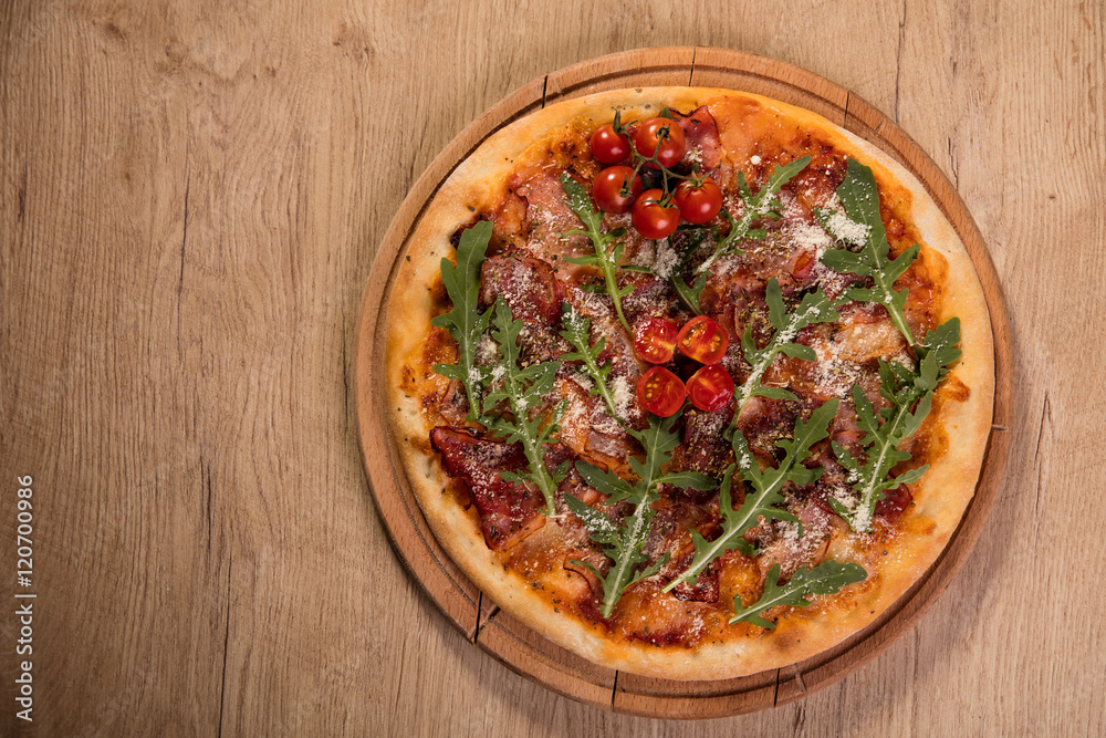 Pizza with meat and arugula served on wooden board Pizza with meat and arugula served on wooden board