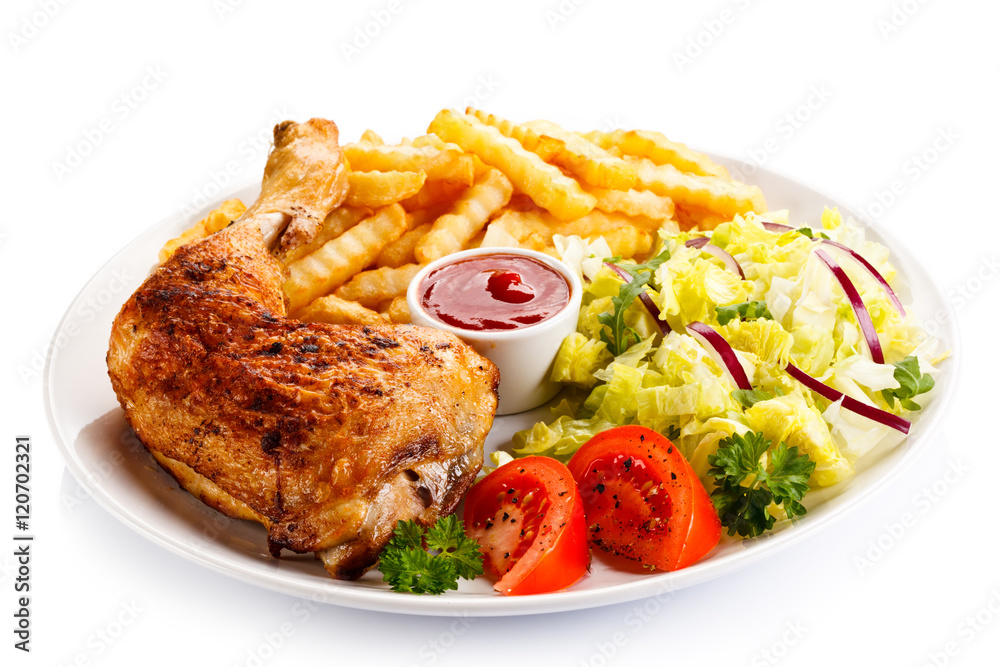 Grilled chicken legs with chips and vegetables Grilled chicken legs with chips and vegetables